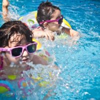 kids swimming in a pool